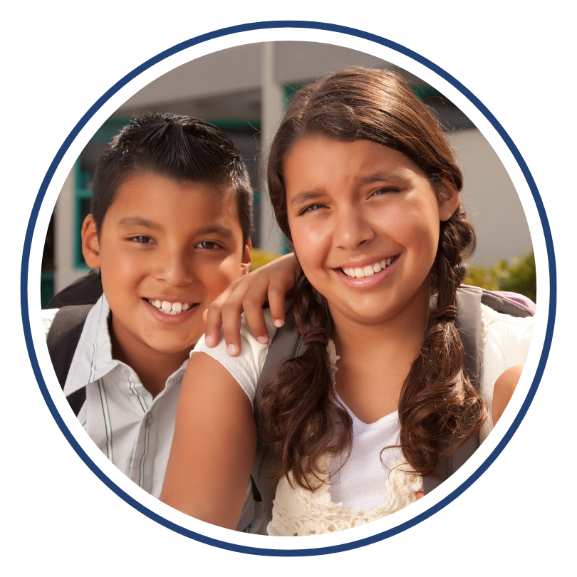 brother and sister pre-teens smile at camera