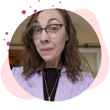 Christina wears a blazer with surprised look on face